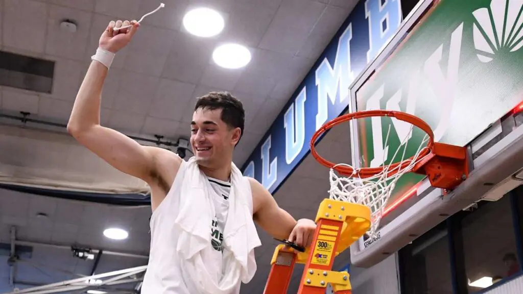 John Poulakidas cuts down the nets for Yale Basketball after winning the Ivy League Conference Tournament. He recently signed a Summer League contract with the Los Angeles Clippers.