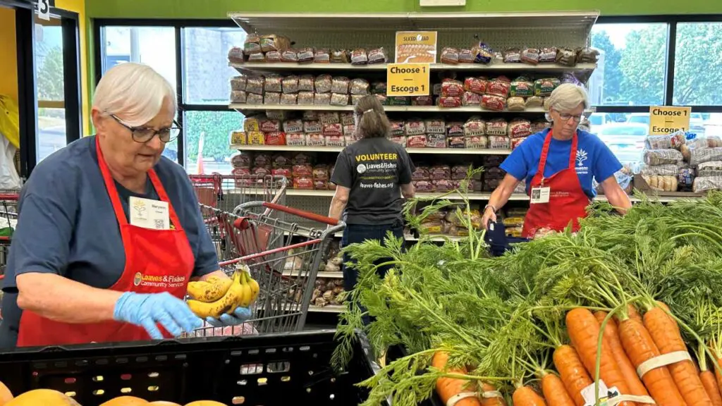 Loaves & Fishes volunteers sort produce.