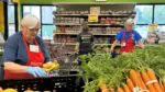 Loaves & Fishes volunteers sort produce.