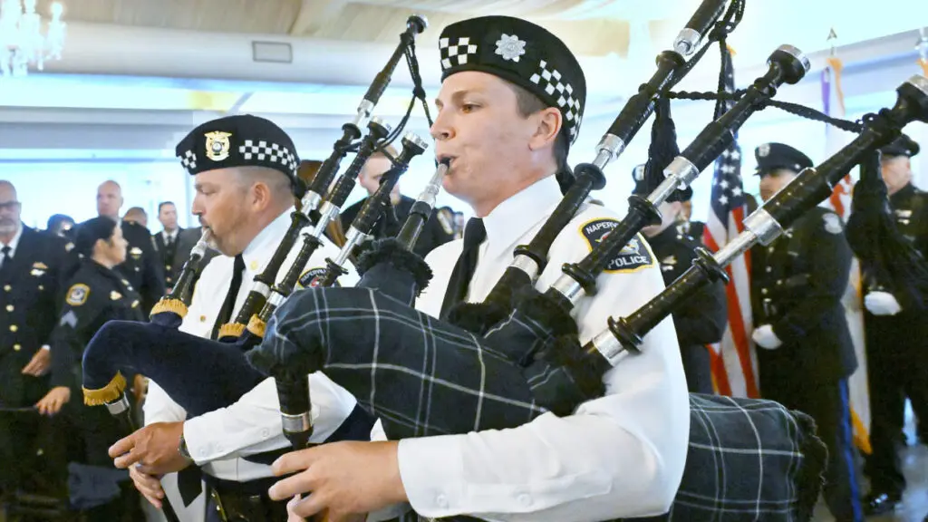 A person plays the bagpipes