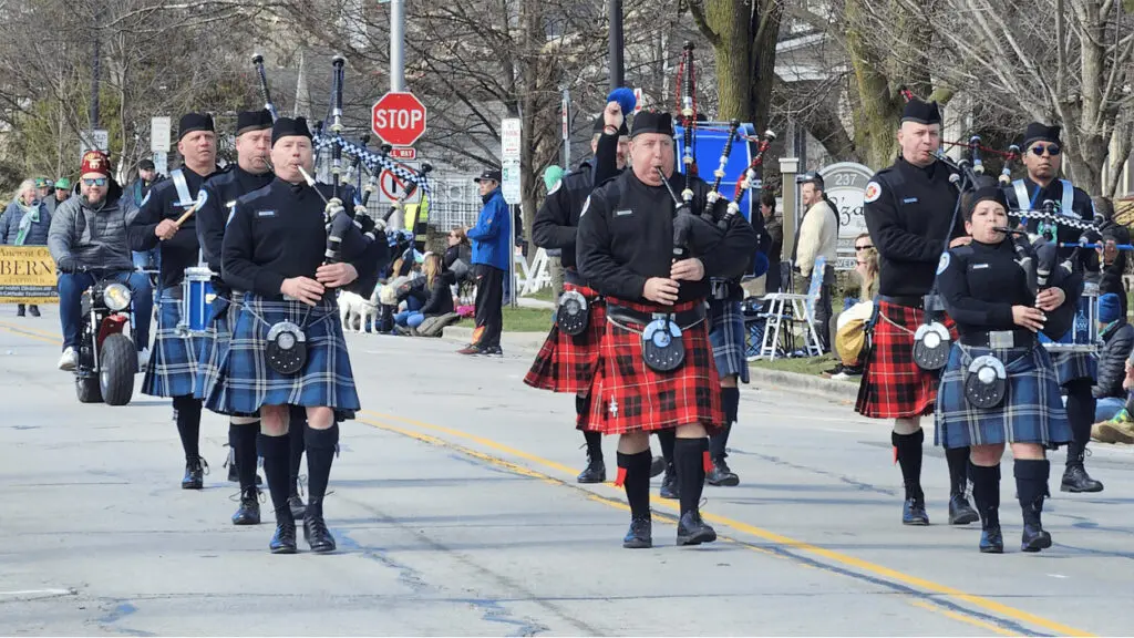 A group of bagpipers marching and performing in Naperville's St. Patrick's Day parade.