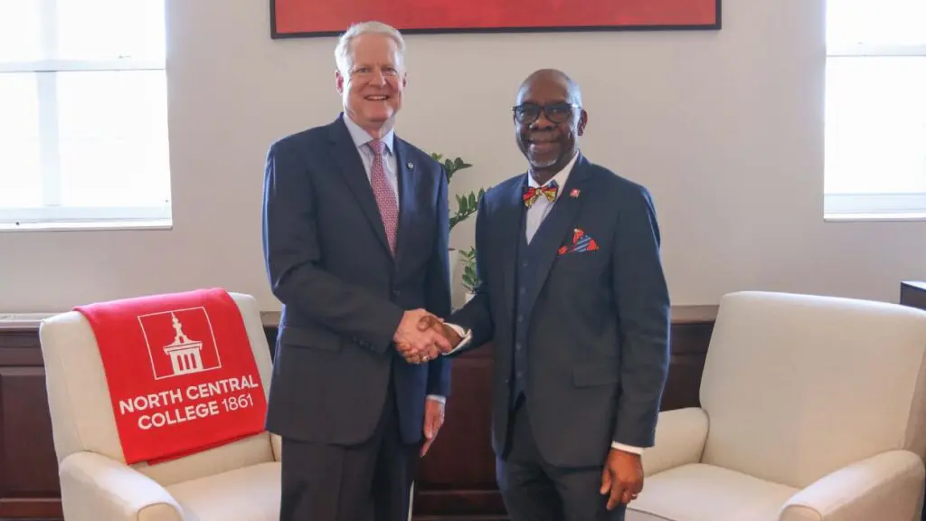 Molex CEO Joe Nelligan (l) shakes hands with North Central College President Abiodun Goke-Pariola