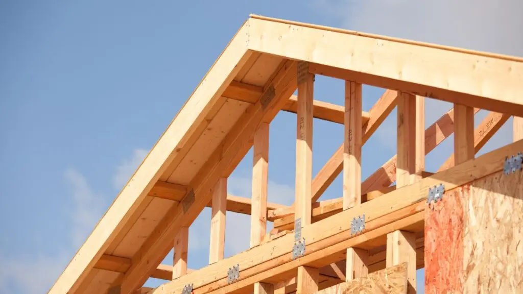 Wood-beamed pointed roof of a housing frame under construction