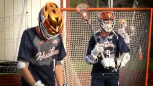 Jake Springer and his teammate warm up before playing Naperville Central.