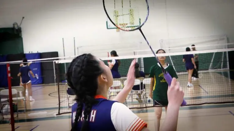 Naperville North badminton player warms up before a singles match against Waubonsie.