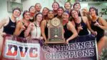 Naperville North girls water polo smiles with the DVC championship trophy.