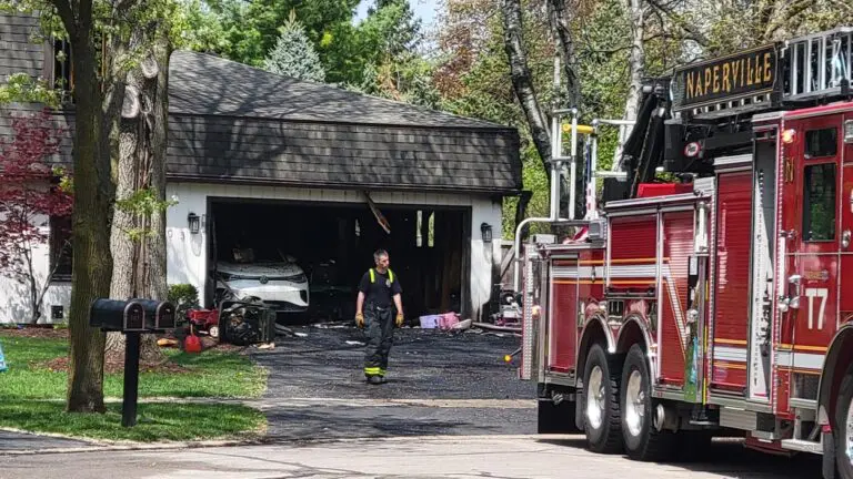 Naperville fire truck on scene at house fire. Quick-thinking neighbors help Naperville family escape fire