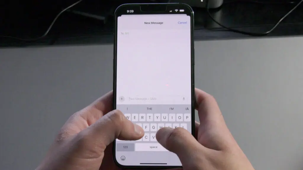 Someone holding their phone while on the text messaging app