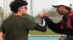 Waubonsie and Naperville North boys tennis player fist bump before match