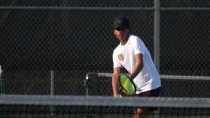 Metea Valley boys tennis player gets ready for serve in matchup against Naperville Central