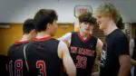 Benet boys volleyball players talk before the game against Neuqua Valley.