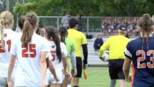 Naperville North girls soccer shuts out Plainfield East 3-0 in the regional semis as the teams walk onto the field.