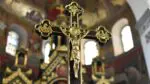 A picture of a black and gold crucifix