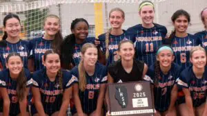 Naperville North girls soccer team smiles for the cameras after winning an IHSA Sectional Final.