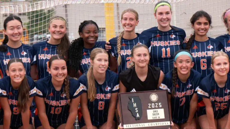 Naperville North girls soccer team smiles for the cameras after winning an IHSA Sectional Final.