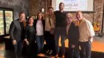 Eight Naperville-area notables chosen to take part in 2025 Dancing with the Celebrities posing in front of stage