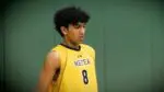 Metea boys volleyball player, Om Patel, serves against DVC rival Waubonsie Valley.