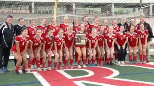 Naperville Central girls soccer smiles with the IHSA Regional Plaque after beating Lockport.