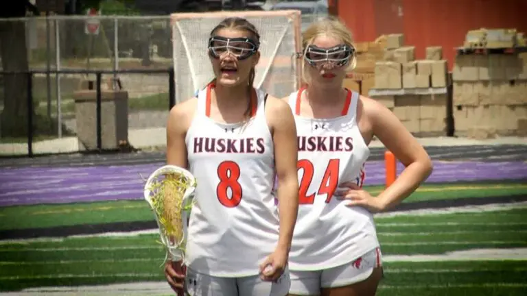 Naperville North girls lax players talk in the warm up line before playing The Valley Co-Op