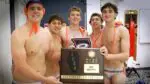 Naperville North boys water polo smiles with the IHSA Boys Water Polo Sectional plaque after beating Waubonsie.