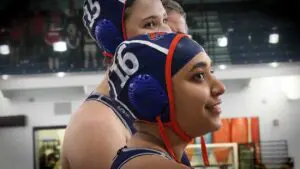 Naperville North girls water polo captains talk with Hinsdale Central before the IHSA Sectional Semifinal.