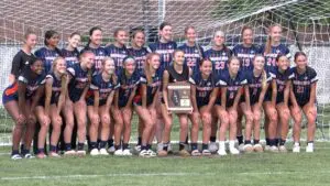 Naperville North Girls Soccer smiles with the Regional plaque after beating Oswego.