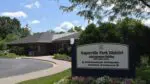 Wide shot of Naperville Park District Administration Building with sign for the building in foreground for story on financial roadmap for district