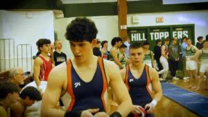 Naperville North boys gymnasts walk out to the floor at the Glenbard West Sectional.