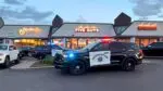Two Naperville police squad cars in front of River Square restaurants in downtown Naperville