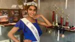 Naperville's Shania Tandon smiles for a picture next to her track and cross country awards. She'll compete at the IHSA track state championship and at the Miss Illinois Teen USA Pageant.