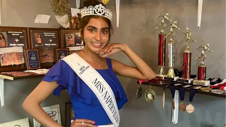 Naperville's Shania Tandon smiles for a picture next to her track and cross country awards. She'll compete at the IHSA track state championship and at the Miss Illinois Teen USA Pageant.