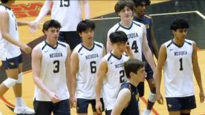 Neuqua Valley boys volleyball players head to the bench before taking on Joliet Catholic in the IHSA Regional Semifinals.