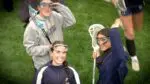 Neuqua Valley girls lacrosse team smiles and waves at the camera before the IHSA Sectional first round matchup
