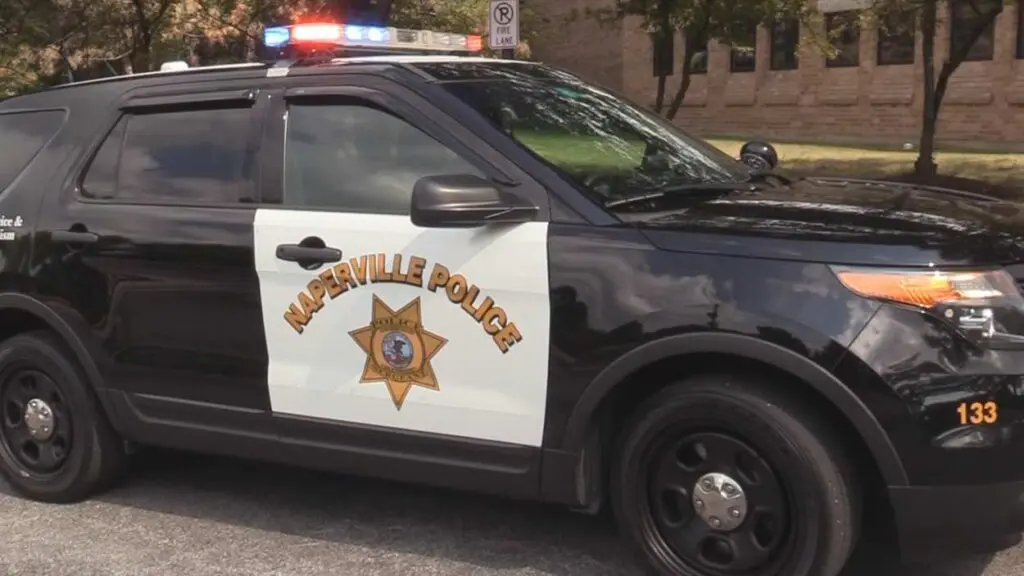 Side view of Naperville police car with flashing lights on