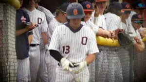 Oswego Baseball player walks out to open the game against Naperville North in the IHSA Regional Semifinals.