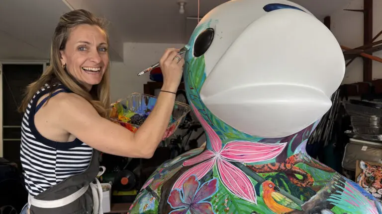 Naperville artist and art teacher Margaret Rubin painting a giant duck sculpture to be on display in downtown Naperville