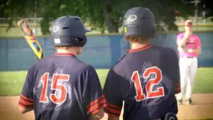 Naperville North baseball players talk before hitting against Neuqua Valley.