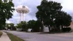 Naperville water tower along with street, buildings, and trees along Naperville's 5th Avenue in area targeted for redevelopment