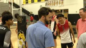 Naperville Central and Metea Valley boys volleyball meet for the coin toss