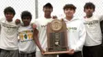 Waubonsie Valley boys tennis team smiles with the DVC Championship trophy.