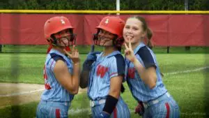 West Aurora Softball players smile and look at the camera before the IHSA Regional Semifinal against Naperville Central.