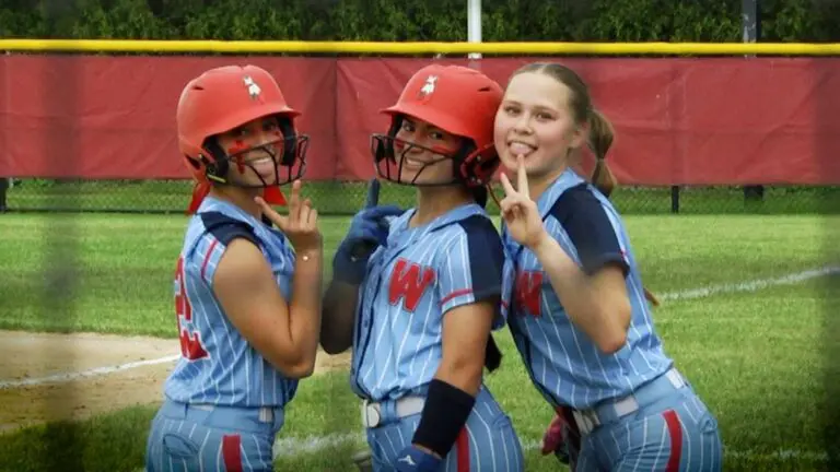 West Aurora Softball players smile and look at the camera before the IHSA Regional Semifinal against Naperville Central.