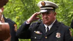 A member of the Naperville Fire Department seen giving a solute and look of solidarity during the annual Fallen Firefighters Memorial