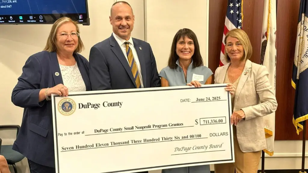 DuPage County Board Human Services Committee Vice-Chair Paula Deacon Garcia, DuPage County Board Human Services Committee Chairman Greg Schwarze, Lynn Dugan, Director of Repeat Boutique and DuPage County Board Chair Deborah Conroy holding giant check for grants to be presented to local nonprofits