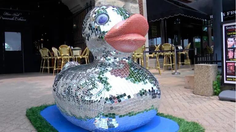 A new shiny disco duck sculpture sits in front of a local business in downtown Naperville, one of the many giant duck sculptures in town.