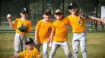 Players from NCTV Naperville Little League Rookies A Team Schuiling pose for a picture to the camera.