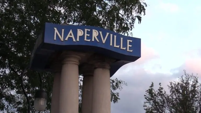 Close up of Naperville sign with tree, sky in background for story on Naperville ranked as third best place in Illinois