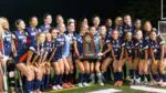 Naperville North girls soccer takes a picture with the IHSA State runner-up trophy.