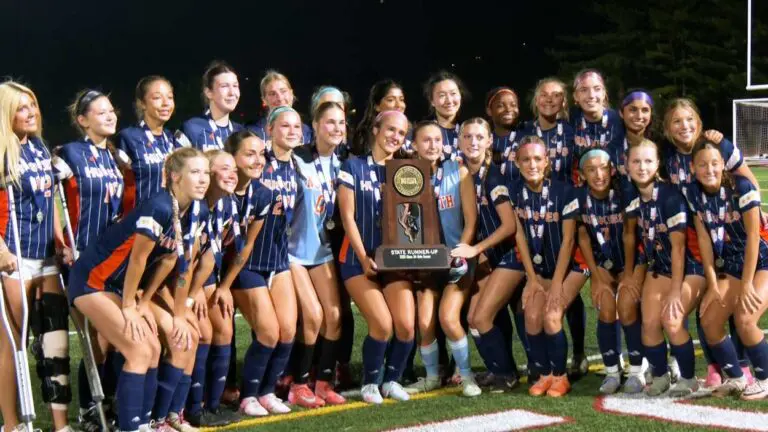 Naperville North girls soccer takes a picture with the IHSA State runner-up trophy.