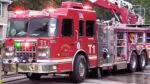 A red Naperville fire truck sits in front of a home.